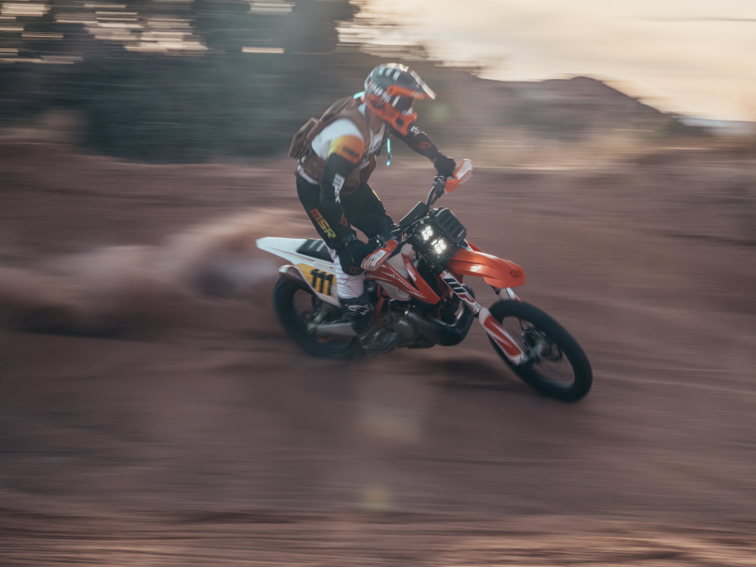 DIRT BIKE WITH HEADLIGHT, RIDING BERM, IN THE SUNSET